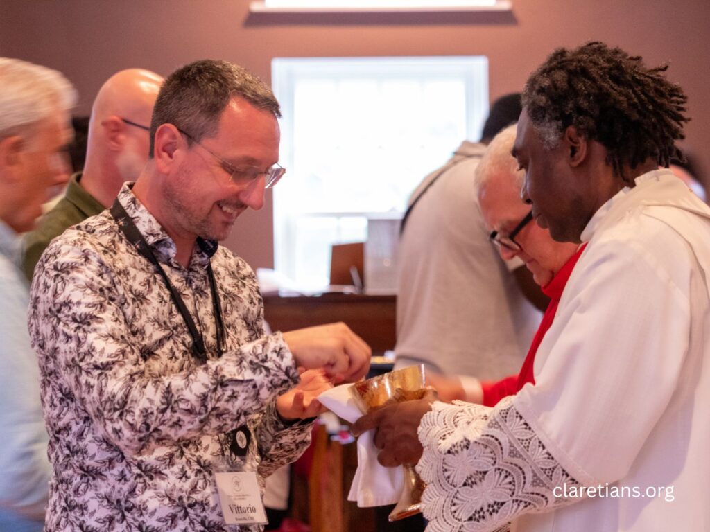 Fr. Vittorio receives Communion at the 2026 Claretian Assembly.